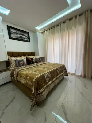 a bedroom with a bed and a large window at Aube Hivernage appartement in Marrakech