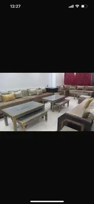 a group of tables and couches in a room at Big confort in Marrakech