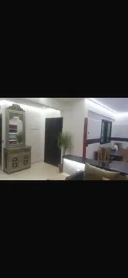 a living room with a mirror and a table at Big confort in Marrakech