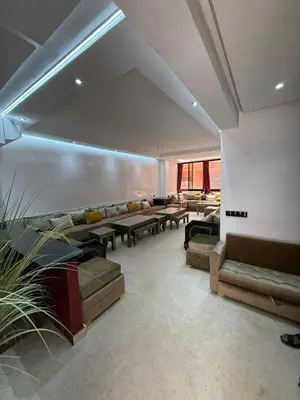 a large living room with couches and tables at Big confort in Marrakech