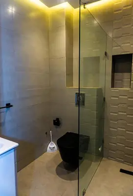 a bathroom with a toilet and a glass shower at Appartement Walili in Marrakech