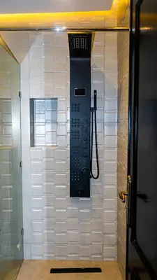 a phone hanging on the wall of a shower at Appartement Walili in Marrakech