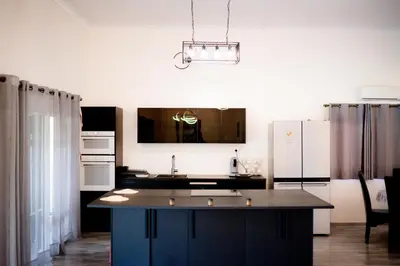 a kitchen with a large island in the middle at Oléa villa & lodge in Marrakech