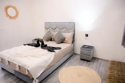 a bedroom with a bed with a mirror and a table at Oléa villa & lodge in Marrakech