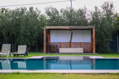 a swimming pool with two chairs and a pavilion at Oléa villa & lodge in Marrakech