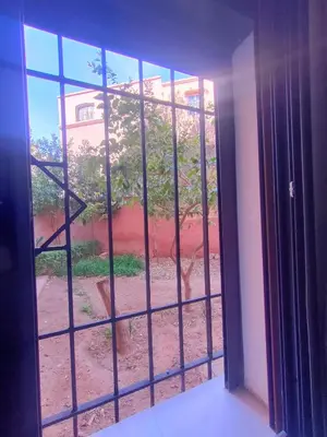 an open window with a view of a tree at Appartement Chic et Confortable, Netflix, PS4 & Wi-Fi Centre Marrakech in Marrakech