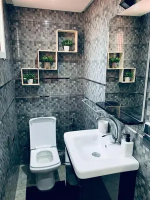 a bathroom with a white toilet and a sink at 3 bedroom duplex with swimming pool in Marrakech