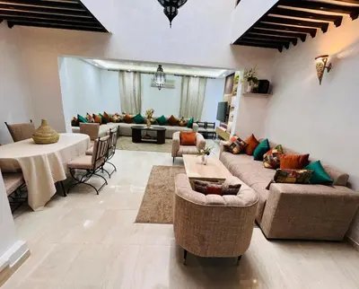 a living room with a couch and a table at 3 bedroom duplex with swimming pool in Marrakech