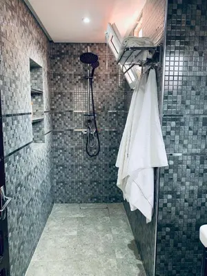 a bathroom with a shower with a white towel at 3 bedroom duplex with swimming pool in Marrakech