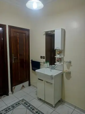 a bathroom with a sink and a mirror at appartement Airport Guests Marrakech in Marrakech