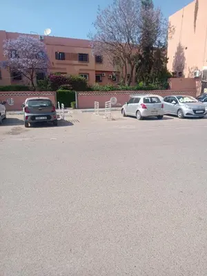 a row of parked cars in a parking lot at appartement Airport Guests Marrakech in Marrakech