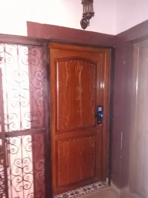 a room with a wooden door and a window at appartement Airport Guests Marrakech in Marrakech