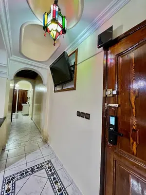 a hallway with a door and a tv on the wall at appartement Airport Guests Marrakech in Marrakech