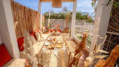a patio with a table and chairs on a balcony at Riad Dar Zioui in Marrakech