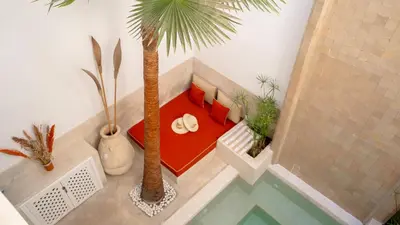 a room with a bed with a palm tree in it at Riad Dar Zioui in Marrakech