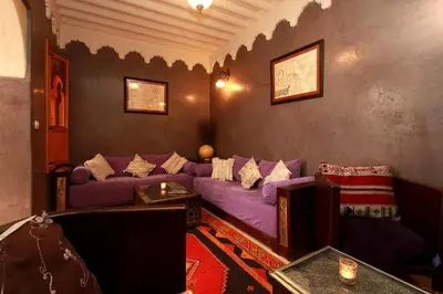 a living room with a purple couch and a table at Riad Khalid Zrika Marrakech in Marrakech