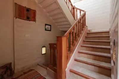 a staircase in a home with wooden railings at Riad Khalid Zrika Marrakech in Marrakech
