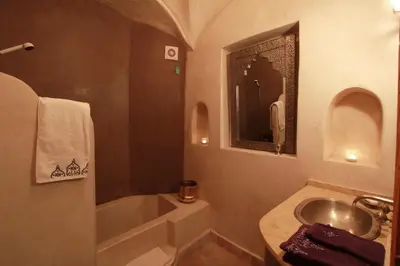 a bathroom with a sink and a bath tub at Riad Khalid Zrika Marrakech in Marrakech