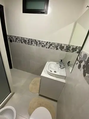 a small bathroom with a sink and a toilet at Condominium in Marrakech