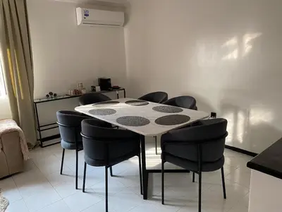 a dining room with a table and chairs at Condominium in Marrakech