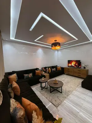 a living room with a couch and a tv at Housna B&B Marrakesh in Marrakech