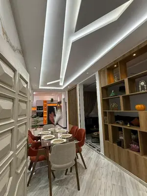 a dining room with a table and chairs in a room at Housna B&B Marrakesh in Marrakech