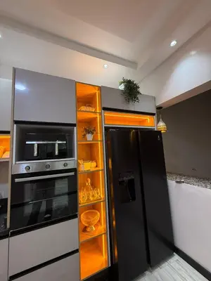 a kitchen with a black refrigerator and a microwave at Housna B&B Marrakesh in Marrakech