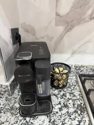 a black coffee maker sitting on a counter at Appartement Haut de Gamme avec Piscine Privée et Grande Terrasse in Marrakech