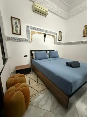 a bedroom with a large bed in a room at RIAD SAAD Marrakech in Marrakech