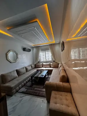 a living room with a couch and a table at Appartement Familial Spacieux & Moderne - Confort et Style au Rendez-vous ! in Marrakech