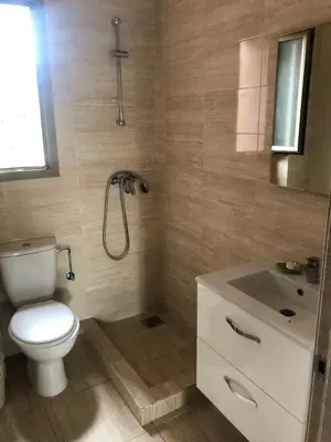 a bathroom with a toilet and a sink at Cozy RC golf view pool & Atlas fiber optic 2 bedrooms in Marrakech