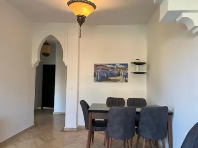 a dining room with a table and chairs at L'oasis d'Atlas Golf Resort in Marrakech
