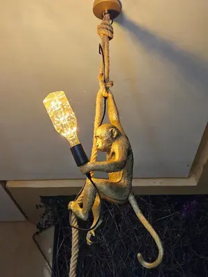 a statue of a monkey hanging from a light pole at Villa in Marrakech in Marrakech