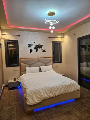 a bedroom with a large bed with blue lighting at Villa in Marrakech in Marrakech