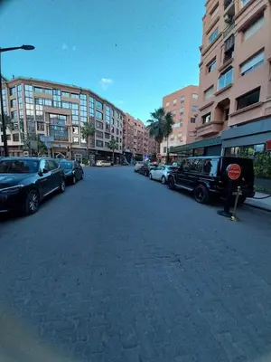 a city street with cars parked in a parking lot at Studio Confort au Cœur de Guéliz proche Carré Eden in Marrakech