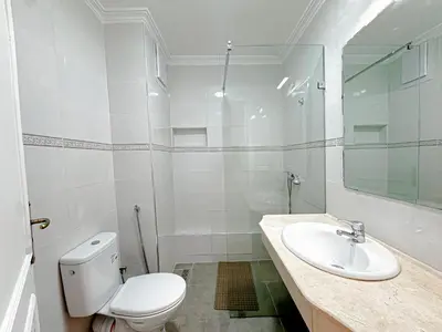 a white bathroom with a toilet and a sink at Studio Confort au Cœur de Guéliz proche Carré Eden in Marrakech