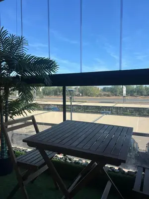 a picnic table and a chair in front of a window at Chanel home in Marrakech