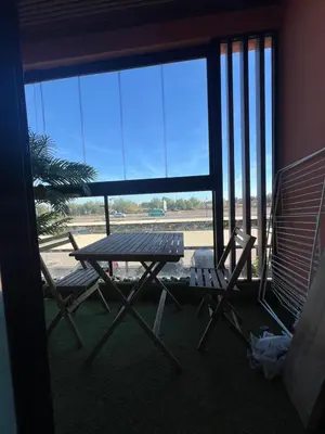 a picnic table and two chairs in front of a window at Chanel home in Marrakech