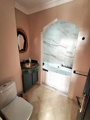 a bathroom with a tub and a sink and a toilet at L'ECRIN de la PALMERAIE in Dar Caïd Layadi