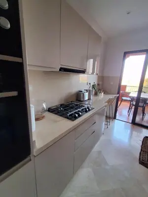 a kitchen with a stove and a counter top at L'ECRIN de la PALMERAIE in Dar Caïd Layadi