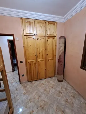 a room with wooden doors and a tiled floor at Sweet home in Marrakech