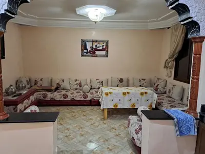 a living room with a couch and a table at Sweet home in Marrakech
