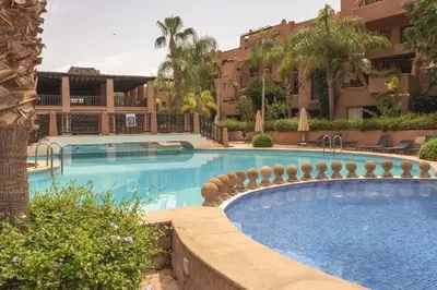 a swimming pool at a hotel with a resort at Agdal Prestige in Marrakech