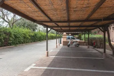 a scooter parked under a covered parking lot at Agdal Prestige in Marrakech