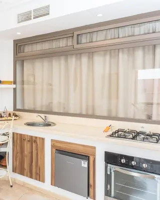 a kitchen with a sink and a stove at Refuge blanc terrasse priveee a cite de Majorelle in Marrakech