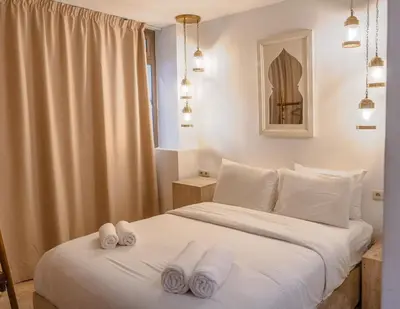 a bedroom with a bed with white towels on it at Refuge blanc terrasse priveee a cite de Majorelle in Marrakech
