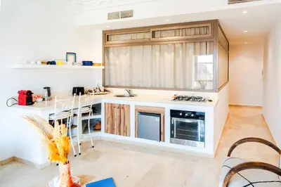 a kitchen with white counters and a stove top oven at Refuge blanc terrasse priveee a cite de Majorelle in Marrakech