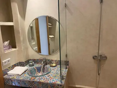 a bathroom with a sink and a mirror at Riad khalid zrika in Marrakech