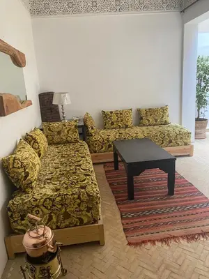 a living room with a couch and a table at Riad khalid zrika in Marrakech