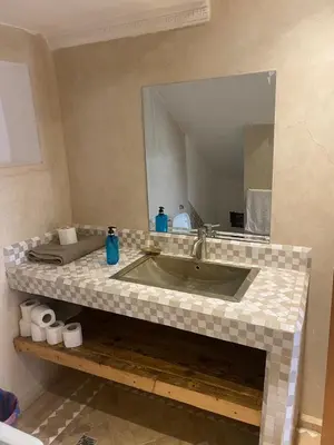 a bathroom with a sink and a mirror at Riad khalid zrika in Marrakech
